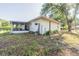 Rear exterior showcasing a covered back patio, shed, and grassy yard at 526 Marklen Loop, Polk City, FL 33868