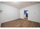 The basement space features wood flooring and a doorway leading to the laundry room at 526 Marklen Loop, Polk City, FL 33868