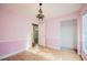 This bedroom has hardwood floors, chandelier, and a view into other parts of the home at 526 Marklen Loop, Polk City, FL 33868