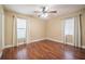 Spacious bedroom featuring hardwood floors, a ceiling fan, and windows allowing for natural light at 526 Marklen Loop, Polk City, FL 33868