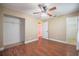 This bedroom boasts hardwood floors, a ceiling fan, and a walk-in closet for ample storage at 526 Marklen Loop, Polk City, FL 33868