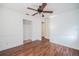 This bedroom has hardwood floors, ceiling fan, and a walk-in closet for all your storage needs at 526 Marklen Loop, Polk City, FL 33868