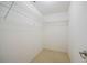 Walk in closet with custom white wire shelving and neutral colored floors at 526 Marklen Loop, Polk City, FL 33868