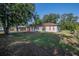 A charming single-story home with a well-maintained lawn, mature trees, and a private driveway at 526 Marklen Loop, Polk City, FL 33868