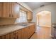 Efficient kitchen with tile floors, wooden cabinets, and a window above the sink at 526 Marklen Loop, Polk City, FL 33868