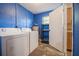 Practical laundry room features a washer and dryer with access to storage shelving and cabinetry at 526 Marklen Loop, Polk City, FL 33868