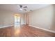 Open-concept living room showcasing hardwood floors and easy access to other rooms at 526 Marklen Loop, Polk City, FL 33868