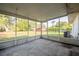Enclosed screened porch provides an indoor/outdoor living experience with views of the backyard and landscaping at 526 Marklen Loop, Polk City, FL 33868