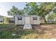 Functional storage shed in backyard with ramp access adds practical storage for tools and equipment at 526 Marklen Loop, Polk City, FL 33868