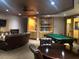 Inviting game room featuring a pool table, lounge area, and custom built-in bookshelves at 530 E Central Blvd # 405, Orlando, FL 32801