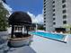 Bright community pool with a swim-up bar, surrounded by lounge chairs and a high-rise building at 530 E Central Blvd # 405, Orlando, FL 32801