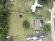 Aerial view of the property showing the house, a trampoline, surrounding trees, and adjacent residential area at 5339 Meadow Grove Trl, Lakeland, FL 33810