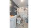 A full bathroom with shower, vanity, and decorative shelves at 5339 Meadow Grove Trl, Lakeland, FL 33810