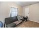 A bedroom with a black futon, gray pillows and white curtains at 5339 Meadow Grove Trl, Lakeland, FL 33810