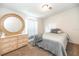 A bedroom with light wooden dresser and oval mirror at 5339 Meadow Grove Trl, Lakeland, FL 33810