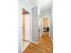 An interior hallway featuring hardwood floors and white door frames at 5339 Meadow Grove Trl, Lakeland, FL 33810