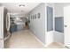 Hallway featuring ceramic tile flooring, gray walls, and easy access to the kitchen and living areas at 5339 Meadow Grove Trl, Lakeland, FL 33810