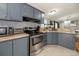 Kitchen with stainless steel appliances, tile floors and granite countertops at 5339 Meadow Grove Trl, Lakeland, FL 33810