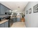 Kitchen featuring stainless steel appliances, gray cabinets and beige counter tops at 5339 Meadow Grove Trl, Lakeland, FL 33810