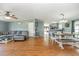 Open-concept living room with hardwood floors, with view of the kitchen and dining area at 5339 Meadow Grove Trl, Lakeland, FL 33810