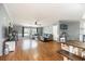 Open-concept living area featuring wood floors, a comfy couch, and stylish decor at 5339 Meadow Grove Trl, Lakeland, FL 33810
