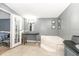 Main bathroom featuring a soaking tub, vanity area, and direct access to the main bedroom at 5339 Meadow Grove Trl, Lakeland, FL 33810