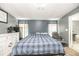 Main bedroom with neutral carpeting, blue accent walls, and a serene seating area at 5339 Meadow Grove Trl, Lakeland, FL 33810