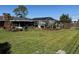 Well maintained backyard with green grass, landscaping and an enclosed patio at 5604 Stratford Ln, Lakeland, FL 33813