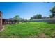 Large green backyard with patio area, landscaped garden, trees and a screened in pool at 5604 Stratford Ln, Lakeland, FL 33813