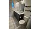 Modern bathroom with a gray vanity, double sinks, marble countertops, and floating shelves at 5604 Stratford Ln, Lakeland, FL 33813