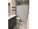 Stylish bathroom featuring a modern vanity, marble countertop, and a tiled shower at 5604 Stratford Ln, Lakeland, FL 33813