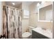 Well-lit bathroom featuring a shower/tub combo, vanity, and patterned shower curtain at 5604 Stratford Ln, Lakeland, FL 33813