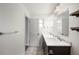 Bathroom featuring a double sink vanity with a marble countertop and tiled floors at 5604 Stratford Ln, Lakeland, FL 33813