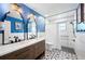Stylish bathroom with dual sinks, decorative mirrors, and a spacious walk-in shower with tile accents at 5604 Stratford Ln, Lakeland, FL 33813