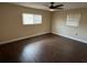 Bedroom featuring wood-look floors, a ceiling fan and window allowing for natural light at 5604 Stratford Ln, Lakeland, FL 33813