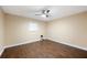 Bedroom features hardwood floors, ceiling fan and ample natural light at 5604 Stratford Ln, Lakeland, FL 33813
