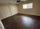 Spacious bedroom with wood-look floors, ceiling fan and bright natural light at 5604 Stratford Ln, Lakeland, FL 33813