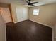 Bedroom with dark floors and ceiling fan at 5604 Stratford Ln, Lakeland, FL 33813