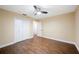 Bedroom features ceiling fan, hardwood floors, closet, and neutral paint at 5604 Stratford Ln, Lakeland, FL 33813