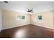 Large bedroom features hardwood floors, ceiling fan, and natural light at 5604 Stratford Ln, Lakeland, FL 33813