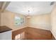 Bright dining room with a hardwood floor and a decorative light fixture at 5604 Stratford Ln, Lakeland, FL 33813