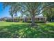 Sprawling brick home with manicured lawn and large shade tree, offering a classic and inviting curb appeal at 5604 Stratford Ln, Lakeland, FL 33813
