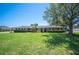 Well-maintained brick home with manicured lawn and mature tree in the front yard showcasing curb appeal at 5604 Stratford Ln, Lakeland, FL 33813