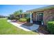 Charming brick home entrance with a black front door, white columns, and well-manicured landscaping at 5604 Stratford Ln, Lakeland, FL 33813