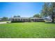 A well-kept brick house, a lush green lawn, and mature trees contribute to the property's curb appeal at 5604 Stratford Ln, Lakeland, FL 33813
