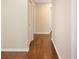 Hallway with hardwood floors connecting various rooms, creating a seamless flow throughout the home at 5604 Stratford Ln, Lakeland, FL 33813