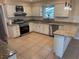 Kitchen with white cabinets and stainless steel appliances at 5604 Stratford Ln, Lakeland, FL 33813
