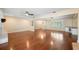 Open concept living space with hardwood floors, ceiling fans, and natural light throughout the home at 5604 Stratford Ln, Lakeland, FL 33813
