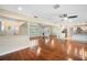 Bright living room with hardwood floors, an open layout, and views of the kitchen and front entrance at 5604 Stratford Ln, Lakeland, FL 33813