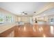 Bright living room boasts hardwood floors, large windows with natural light, and a seamless open floorplan at 5604 Stratford Ln, Lakeland, FL 33813